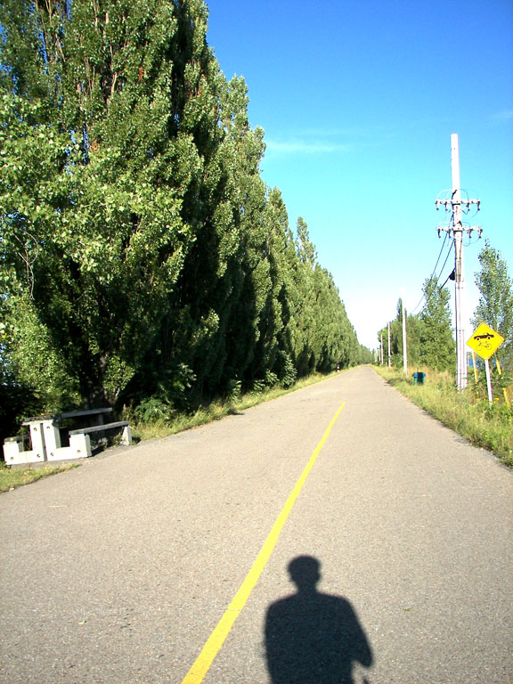 This is what the road looks like on the wave breaker. The subject is my lone shadow on the bike and the context is the long stretch of road and yes, I shot my shadow on purpose.